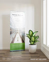 Roll Up Banner Mockup With A Plant Beside The Window Psd
