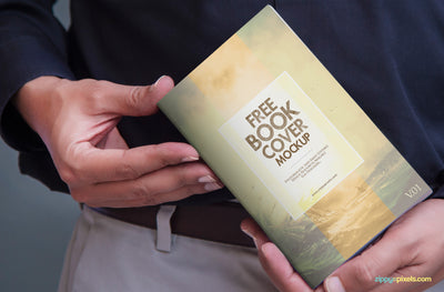 Book Cover Mock Up PSD in Mans Hand