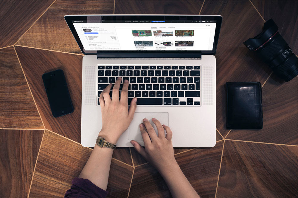 Woman Typing on a Macbook Pro Top View Mockup
