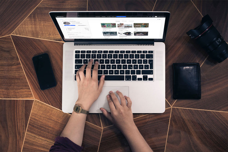 Woman Typing on a Macbook Pro Top View Mockup