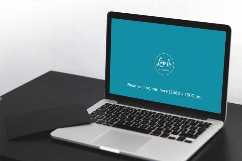 Macbook Pro On A Black Table Mockup