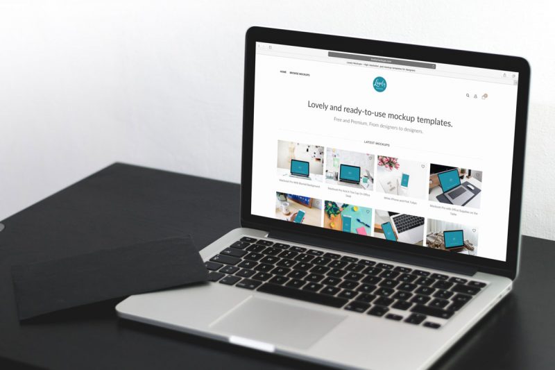 Macbook Pro On A Black Table Mockup