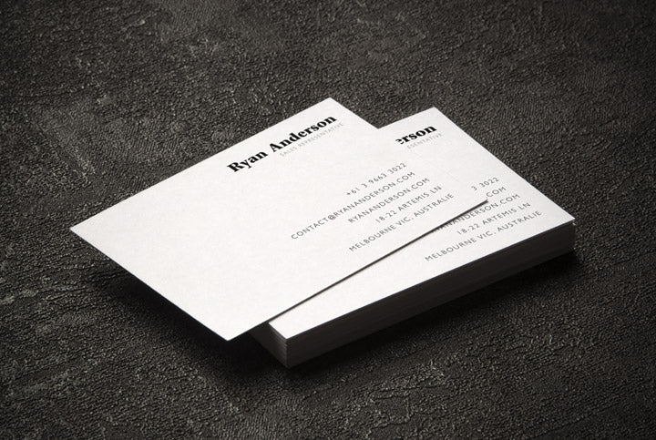 Two Business Cards on a Black Surface