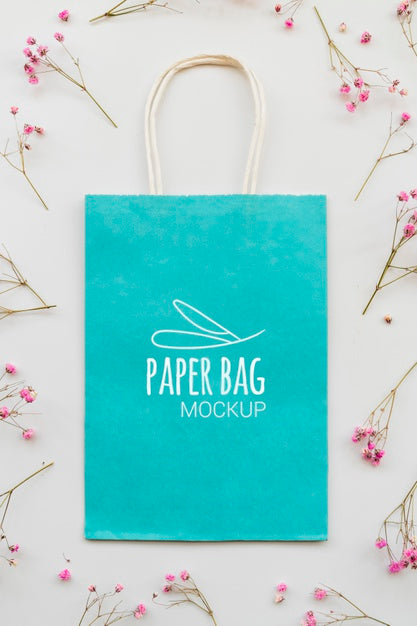 Above View Flowers And Paper Bag Assortment Psd