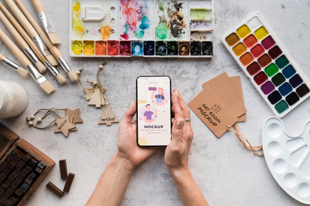 Acrylic Palette And Brushes Beside Mobile Psd