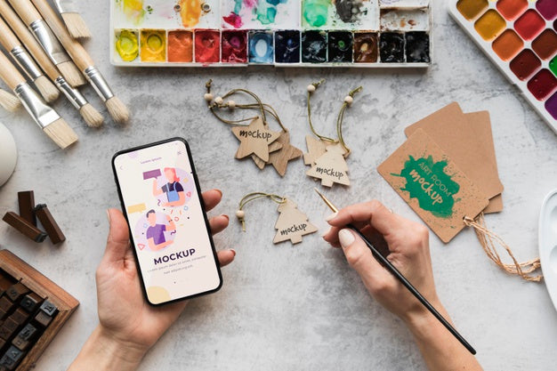 Acrylic Palette And Brushes Beside Mobile Psd