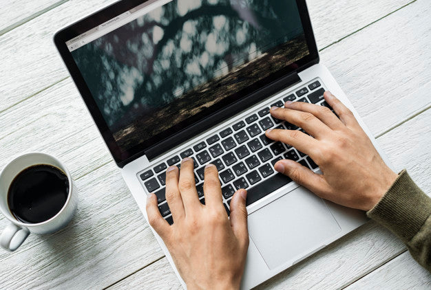 Aerial View Of A Man Using Computer Laptop On Wooden Table Psd