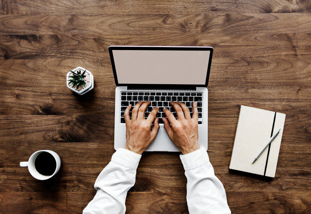 Aerial View Of A Man Using Computer Laptop On Wooden Table Psd