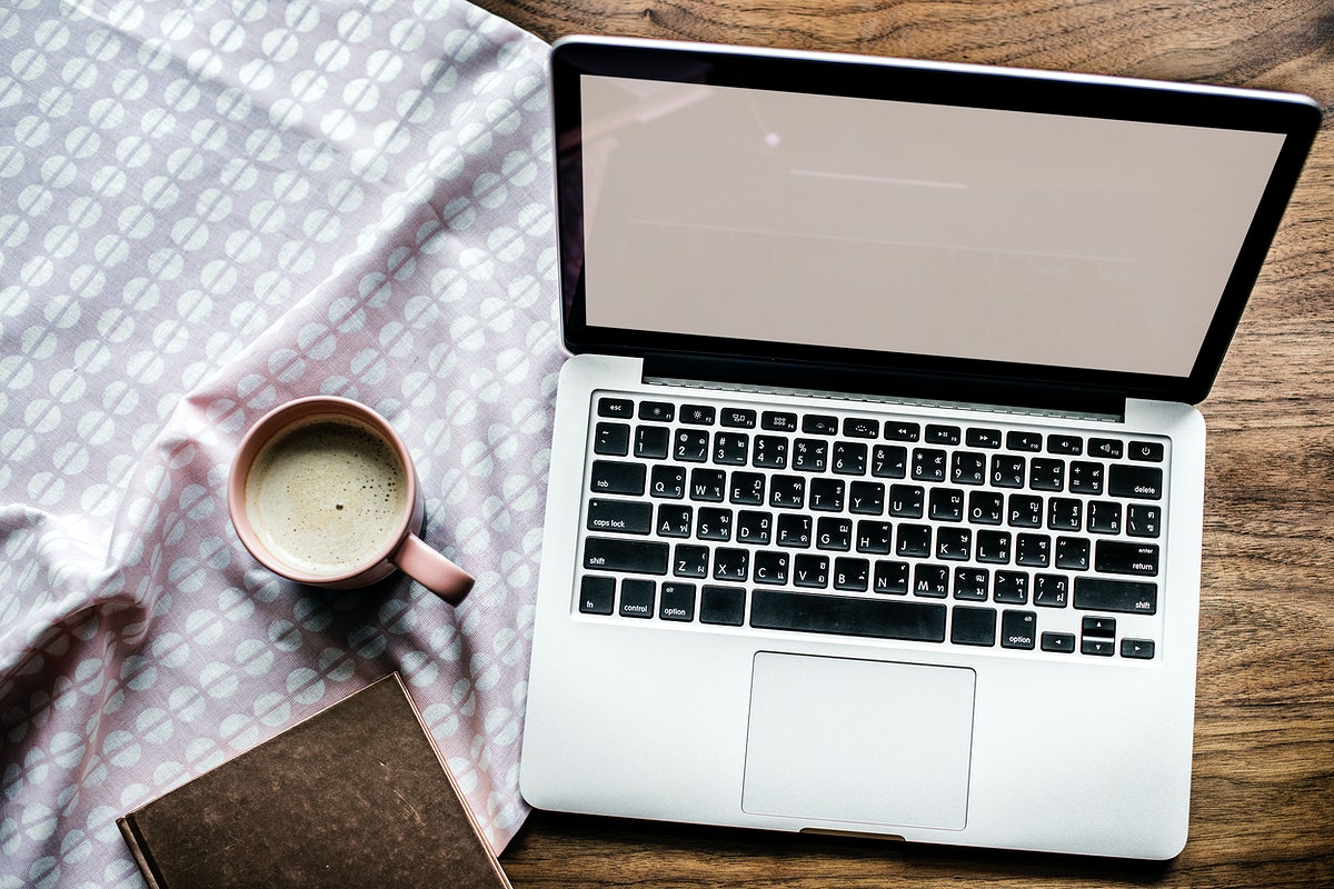 Aerial View Of Computer Laptop On Wooden Table And A Cup Of Hot Milk