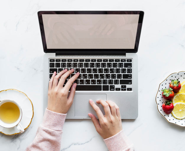 Aerial View Of Woman Using A Laptop On A Marble Table With Design Space Psd