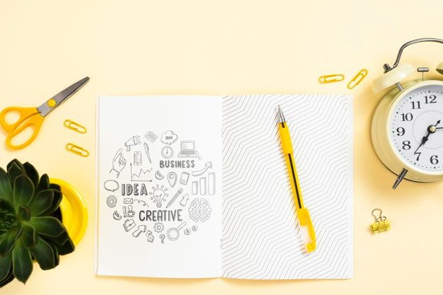 Agenda On Workspace With Plant And Clock Psd