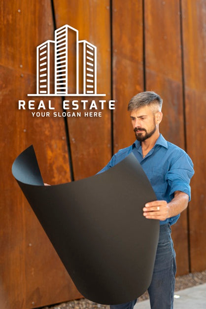 Agent Looking At Plans With Wooden Background Psd