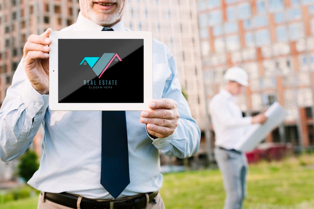 Architect Holding A Tablet Mock-Up In Front Of A Building Psd