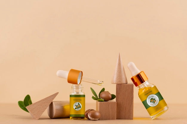 Argan Oil Cosmetic Bottle Mock-Up With Wooden-Shaped Podium And Kernels Psd