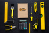 Arrangement Of Different Repairing Tools With Notepad Mock-Up On Black Background Psd