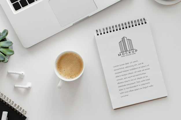 Arrangement With Mock-Up Notepad On A Desk Psd