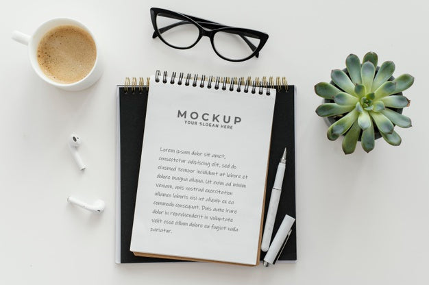 Arrangement With Mock-Up Notepad On A Desk Psd