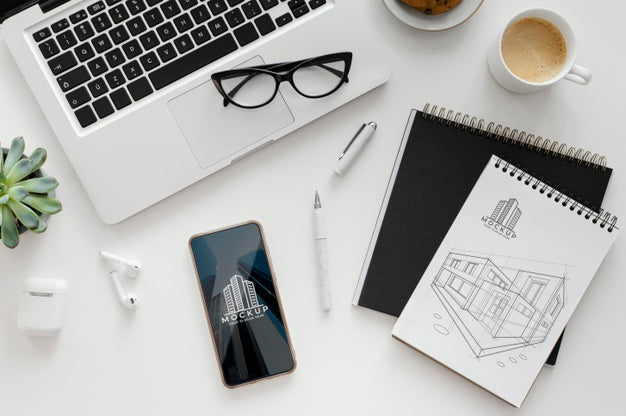 Arrangement With Mock-Up Notepad On A Desk Psd