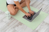 Athletic Woman Doing Yoga At Home With Laptop Psd