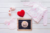 Baby Mockup With Girl Clothes And Slate Psd