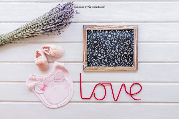 Baby Mockup With Slate And Pink Bib Psd