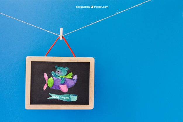 Baby Mockup With Slate Hanging On Clothes Peg Psd