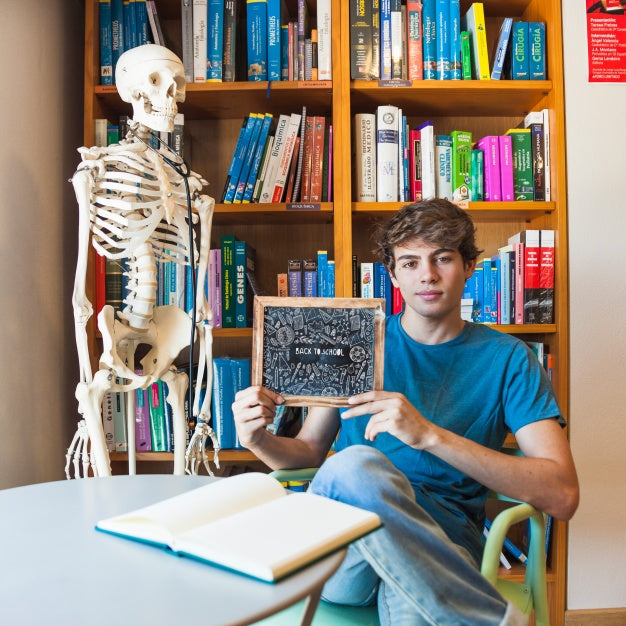 Back To School Concept With Boy Showing Slate Psd