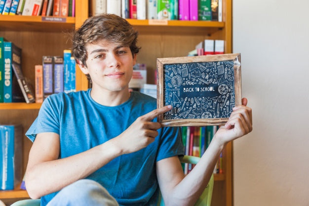 Back To School Concept With Boy Showing Slate Psd