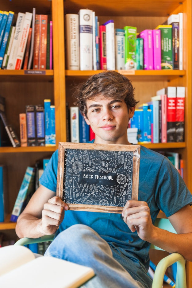 Back To School Concept With Boy Showing Slate Psd