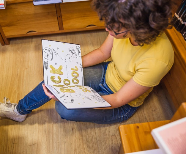 Back To School Concept With Girl Reading Book In Library Psd