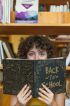 Back To School Concept With Girl Reading Book In Library Psd