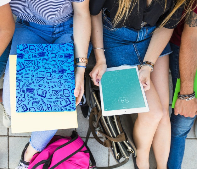 Back To School Concept With Girls Looking At Tablet And Cover Psd