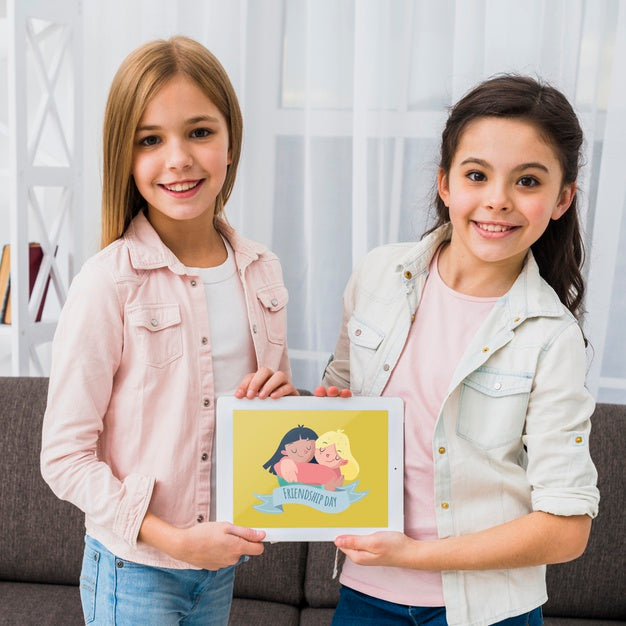 Best Friends Holding A Tablet Together Mock-Up Psd