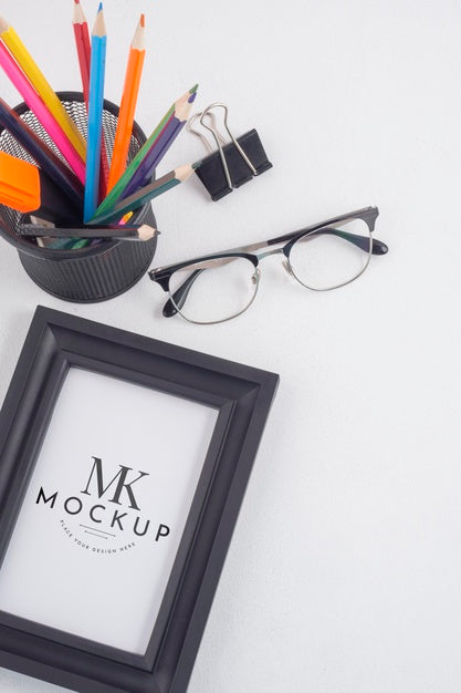 Black Frame Mock-Up Next To Stationery Elements Arrangement Psd