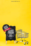 Black Friday Mockup With Shopping Cart Next To Board Psd