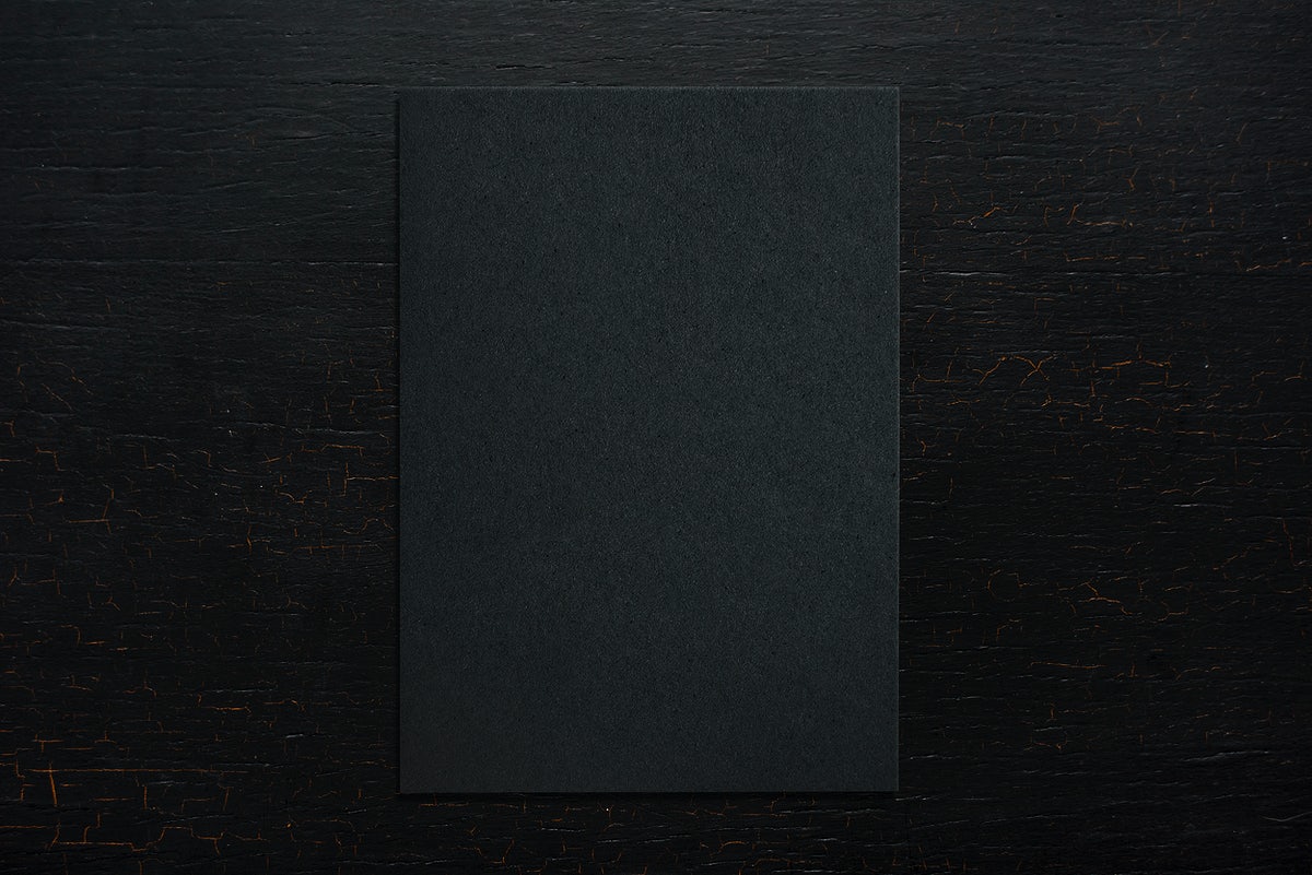 Black Paper On A Wooden Background