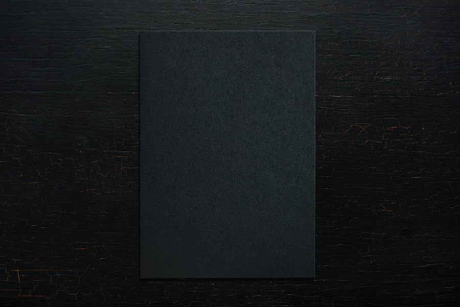 Black Paper On A Wooden Background