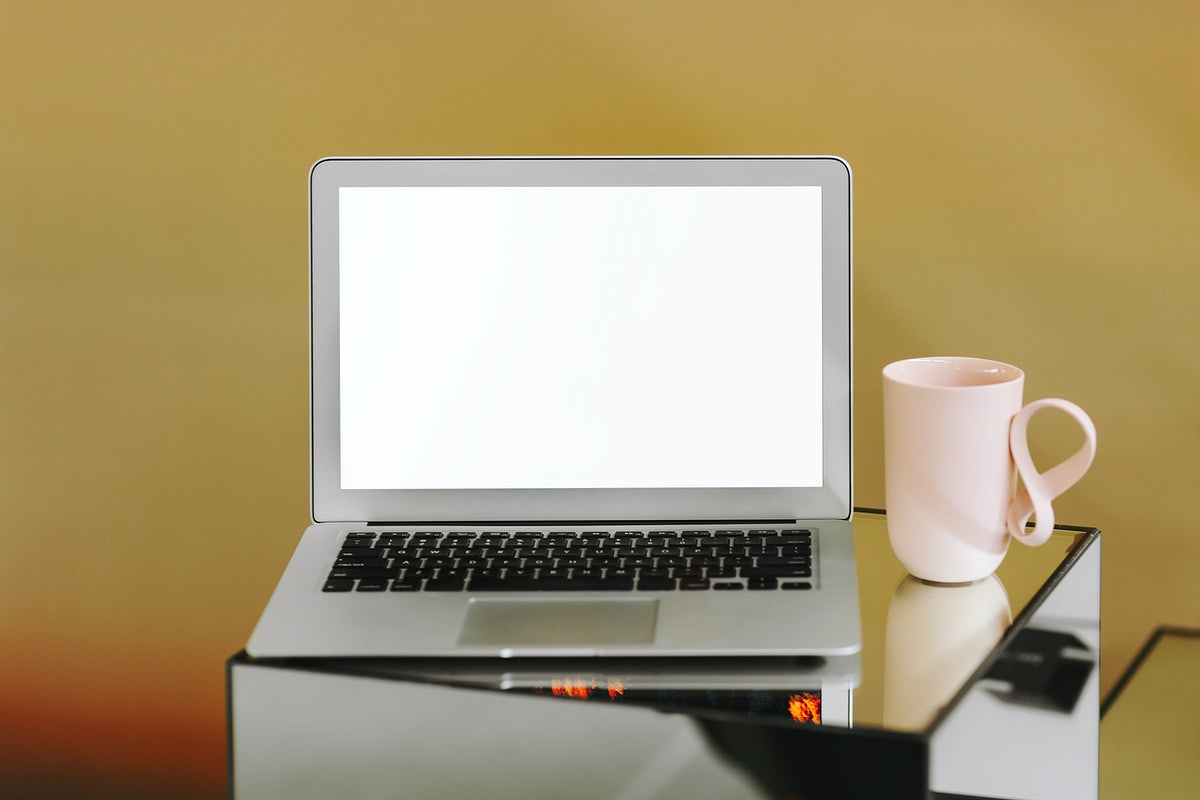 Blank Laptop Screen And A Pink Coffee Cup