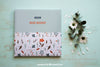 Book Mockup Next To Flowers Psd
