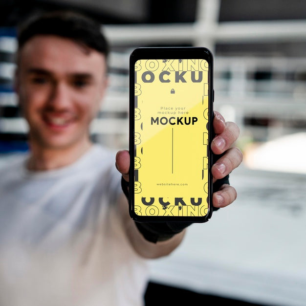 Boxing Athlete Holding A Mock-Up Phone Psd