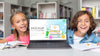 Boy And Girl In Library With Mock-Up Laptop Psd