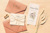 Brown Paper Envelopes With Wedding Invitations And Rings Psd
