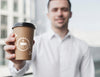 Business Man Holding Up A Coffee Cup Mock-Up Psd