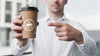 Business Man Pointing At A Coffee Cup Mock-Up Psd