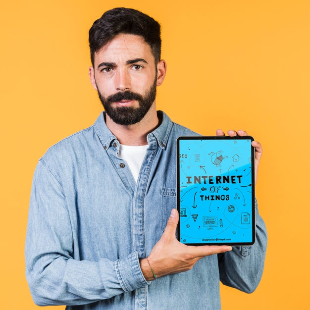 Casual Young Man Holding A Tablet Mock Up Psd