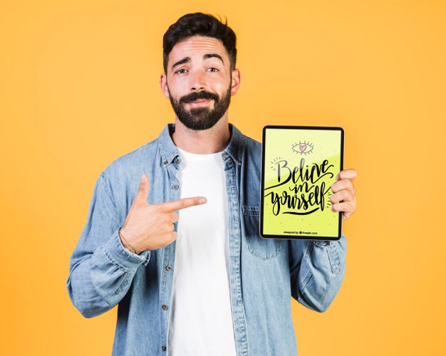 Casual Young Man Pointing Finger To A Tablet Mock Up Psd