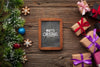 Chalkboard Mock-Up And Gifts With Christmas Pine Leaves Psd