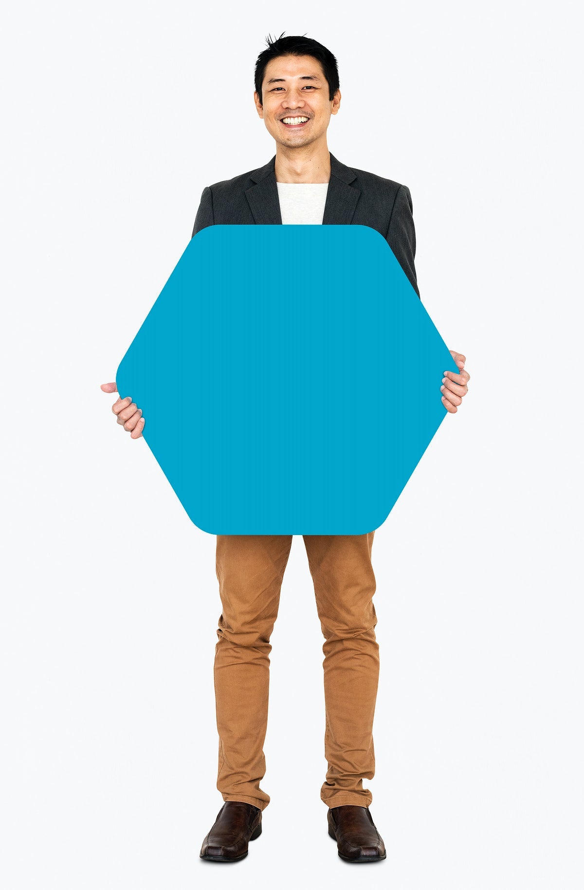 Cheerful Man Showing A Blank Blue Hexagon Shaped Board