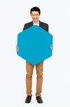 Cheerful Man Showing A Blank Blue Hexagon Shaped Board