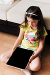 Child Sitting On A Floor With A Digital Tablet In Her Hands Psd